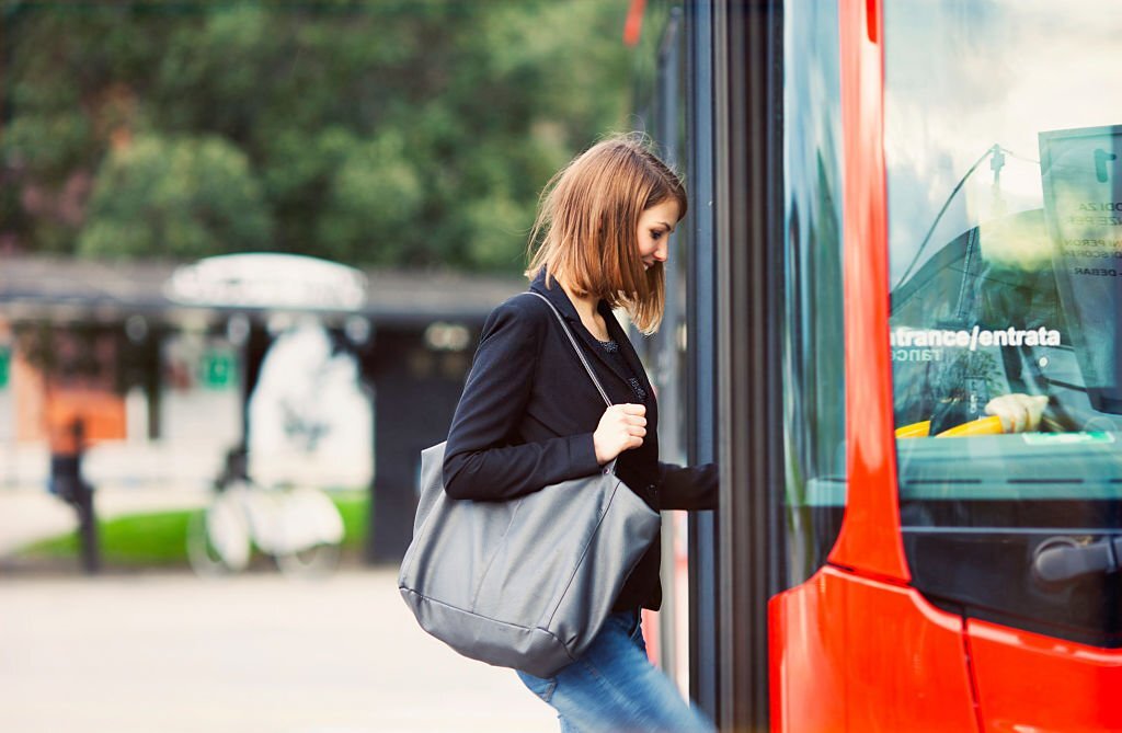 Young female boarding a city bus